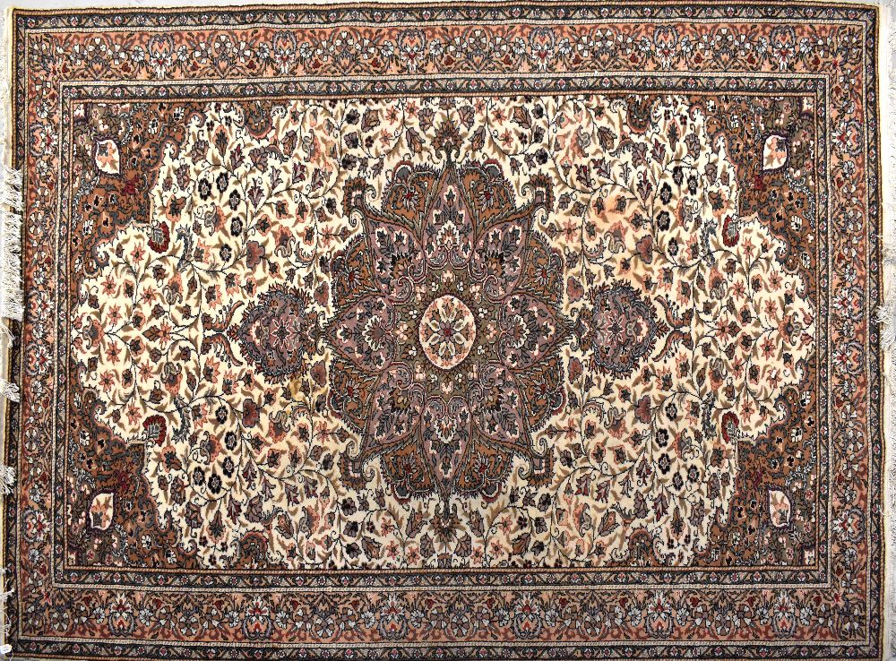 A Turkish wool Kayseri carpet with central medallion on a cream ground and within floral