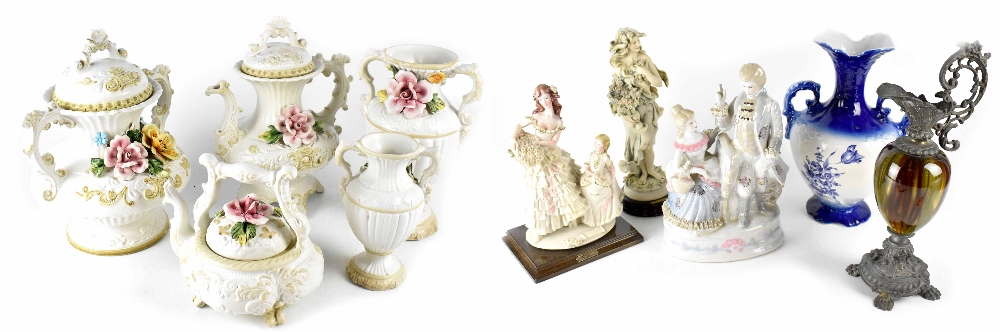 A Capodimonte porcelain six-place tea set with embossed putti decoration on gilt and black ground,