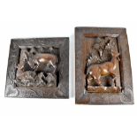 A pair of Indonesian carved hardwood panels, each depicting ruminant animals, within carved borders,