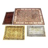 A Kashmir wool rug with floral and scrolling leaf motifs on a green ground within multi-borders,