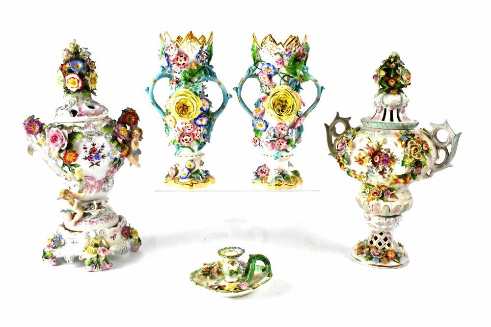 Two non-matching late 19th century Continental hand painted and floral bocage decorated vases with