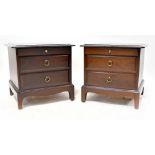 A pair of Stag Minstrel bedside tables, each with two drawers with ring handles, on bracket feet,