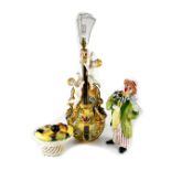 A Continental porcelain lamp base in the form of a violin with putti and encrusted with roses,