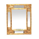 A reproduction gilt-framed mirror, rectangular bevelled plate with mirrored glass and scroll border,