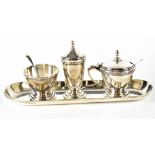 A George VI hallmarked silver three-piece cruet set on a tray,