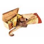A large mahogany box containing vintage gold velvet fabric curtain trims,