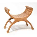 A modern teak Savonarola chair, width 72cm.