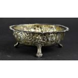 A Victorian hallmarked silver floral repoussé decorated bowl on three paw supports, diameter 13cm,