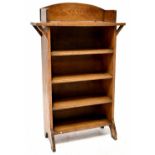 An Arts & Crafts oak floorstanding bookcase with galleried top above five shelves, on stile feet,