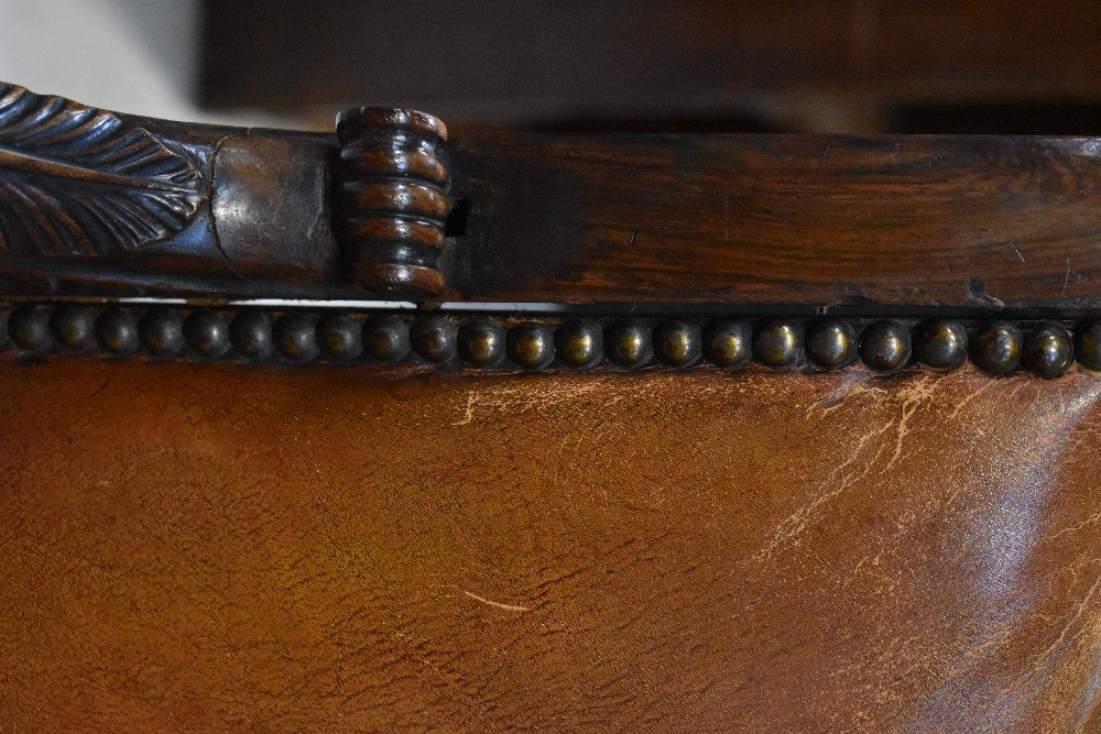 A 19th century rosewood open arm library chair with foliate and Athenian carved top rail, - Image 7 of 7