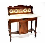 An Edwardian mahogany wash stand with marble top and tiled gallery above a base with cupboard and
