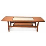 A Schreiber teak coffee table of rectangular form with inset smoky glass centre above undershelf,