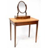 An Edwardian mahogany swing toilet mirror with oval plate on slender supports,