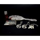 A hallmarked silver hand mirror, a cranberry perfume bottle with hallmarked silver top,