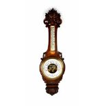 Morath Brothers; a late Victorian carved oak aneroid barometer/thermometer,