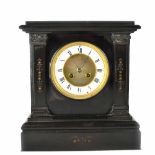 A late Victorian black slate eight-day mantel clock,