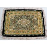 An Indian embroidered and bejewelled rug decorated with cabochon mounted floral arabesques within a