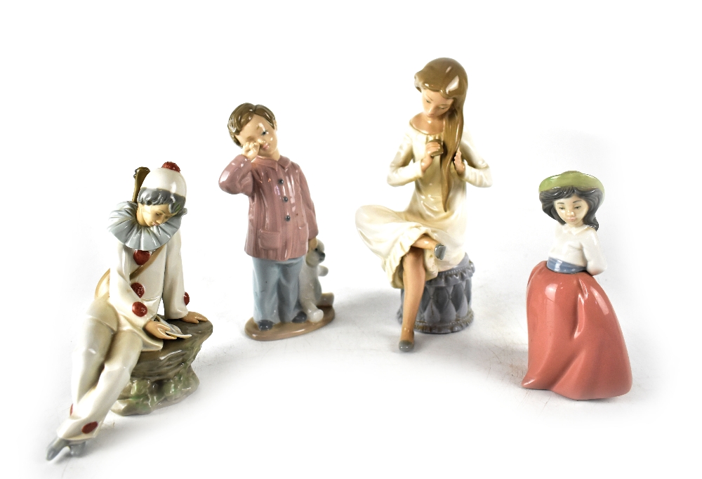 Four Nao figures to include a seated girl combing her hair, height 23cm, a clown,