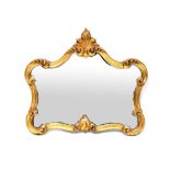 A Rococo-style gilt-framed mirror with shaped plate, in frame of carved C-scroll motifs, 68.