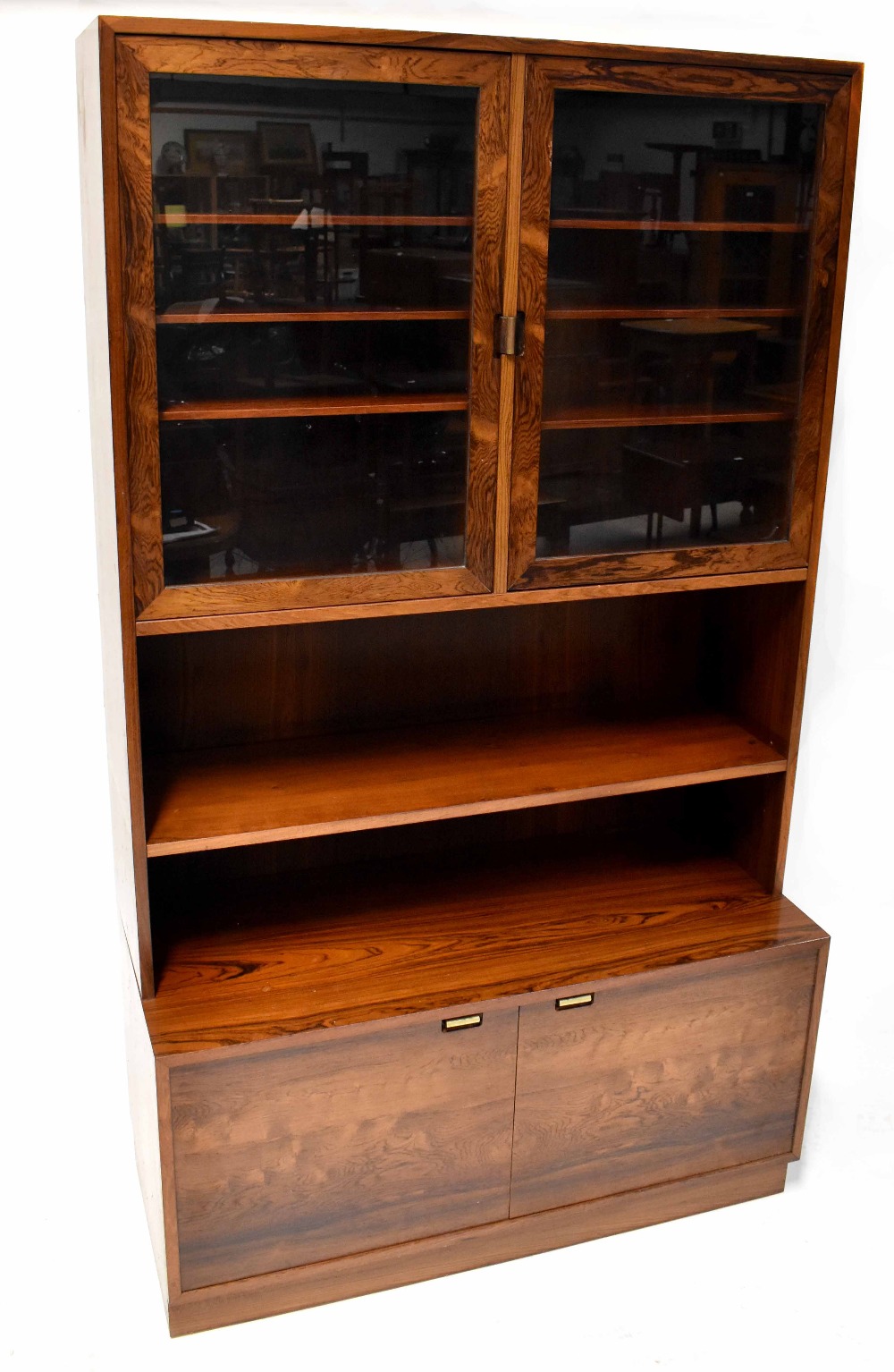 A Danish mid-20th century rosewood display cabinet with glazed top over open shelves,