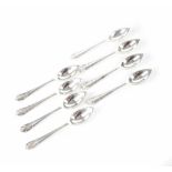 A set of eight George V hallmarked silver grapefruit spoons with Art Nouveau style finials,