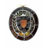 A stained glass panel in the 16th century style of oval shape,