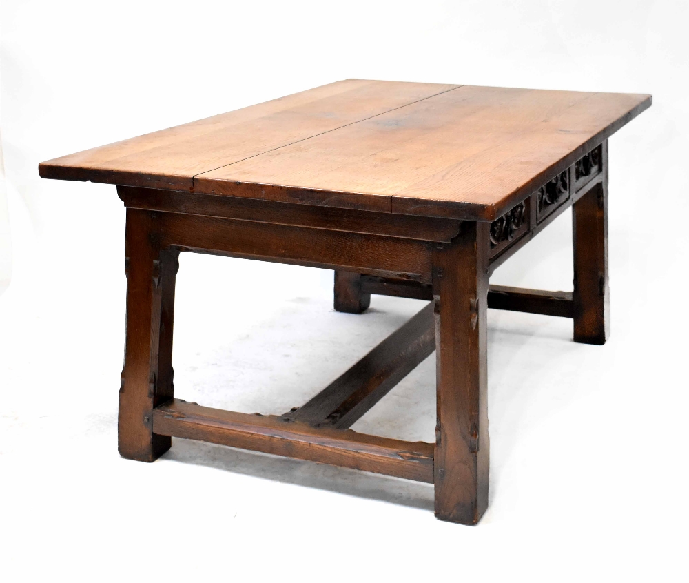 A large oak Gothic Revival refectory table with three drawers to each side with carved decoration