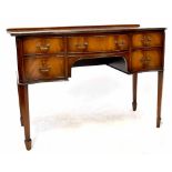 A reproduction mahogany bow-fronted dressing table with five drawers,