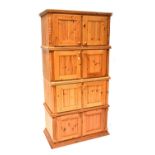 A waxed pine four-tier cupboard with four pairs of cupboard doors on a plinth base, 202 x 99.
