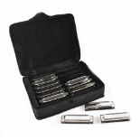 Chord; set of twelve blues ten harmonicas, in various keys, in fabric and hard form zip carry case.