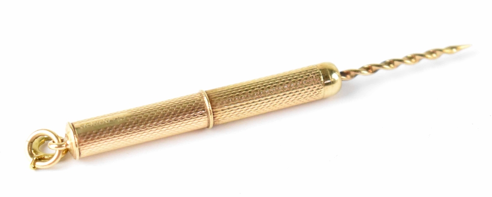 A hallmarked 9ct gold retractable twist end toothpick with engine turned body, Birmingham 1965,