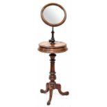 A Victorian mahogany shaving stand with an adjustable oval mirror on a turned stand,