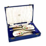 An Elizabeth II Art Deco style hallmarked silver and engine turned enamel four-piece dressing table