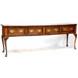 An 18th century oak dresser base of large proportions comprising four frieze drawers,