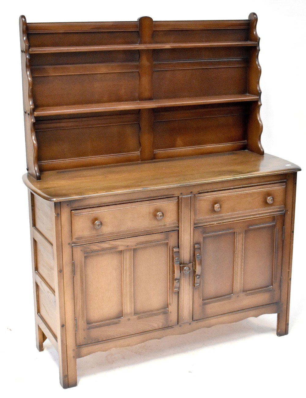 An Ercol dark stained elm dresser with enclosed plate rack above a base of two drawers and two