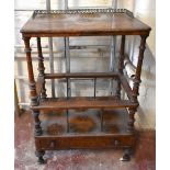 A Victorian inlaid walnut whatnot with base drawer on turned column supports, height including