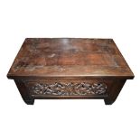 A large Eastern hardwood rectangular coffee table, the sides set with carved panels, 130 x 76 x
