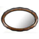 A shaped oval mirror with beaded detail and bevelled plate, 56 x 83cm.Additional