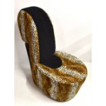 A stylish contemporary chair modelled as a stiletto shoe, in leopard print upholstery.