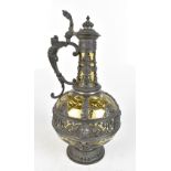 An early 20th century pewter mounted wine ewer, with mask head and scrolling detail with an amber