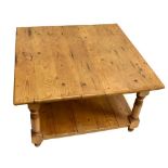 A large pine square two tier coffee table on turned supports, width 90cm depth 87cm.