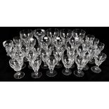 STUART CRYSTAL; a set of approximately fifty glasses of graduated size with lens cut bowls to