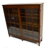 An early 20th century mahogany display cabinet with pair of twelve-pane glazed doors on square