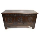 An 18th century carved and panelled oak coffer and initials MW to the front, replacement hinges,