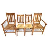 A set of four Arts & Crafts oak framed chairs with pierced detail and rush seats (2+2) (4).