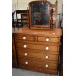 A Victorian Gothic Revival pine and inlaid mirror back dressing chest with two short and three