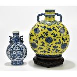 A late 19th century Chinese blue and white porcelain twin handled moon flask painted with four-