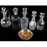 Five 19th century and later glass decanters and claret jug, also a silver mounted bottle stand (6).