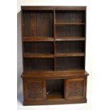 An early 20th century oak bookcase, the later top section with an arrangement of adjustable
