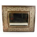 An Arts & Crafts sheet copper wall mirror with embossed floral decoration, 50 x 59cm.Additional